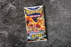 A detailed shot of a sealed Pokémon booster box with vibrant artwork visible.