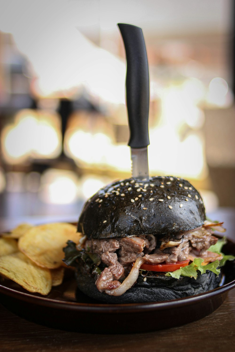 a hamburger with a knife on top