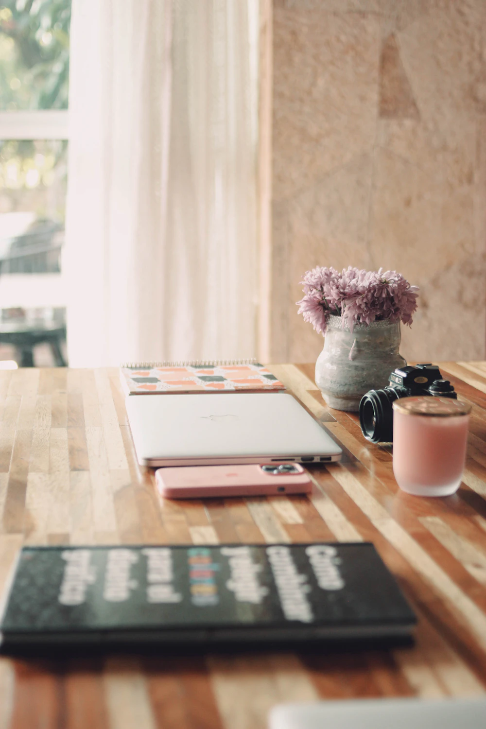 Bureau de préparation de mariage avec carnet, appareil photo et fleurs pour établir le budget