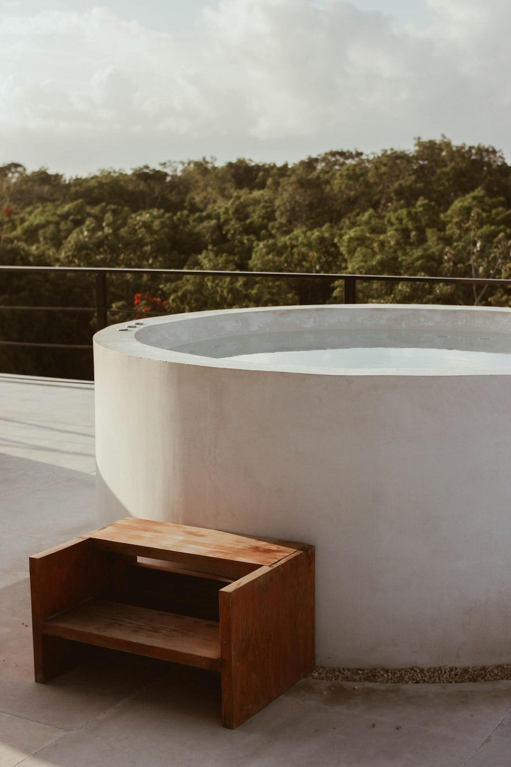 a tub with a bench in front of it