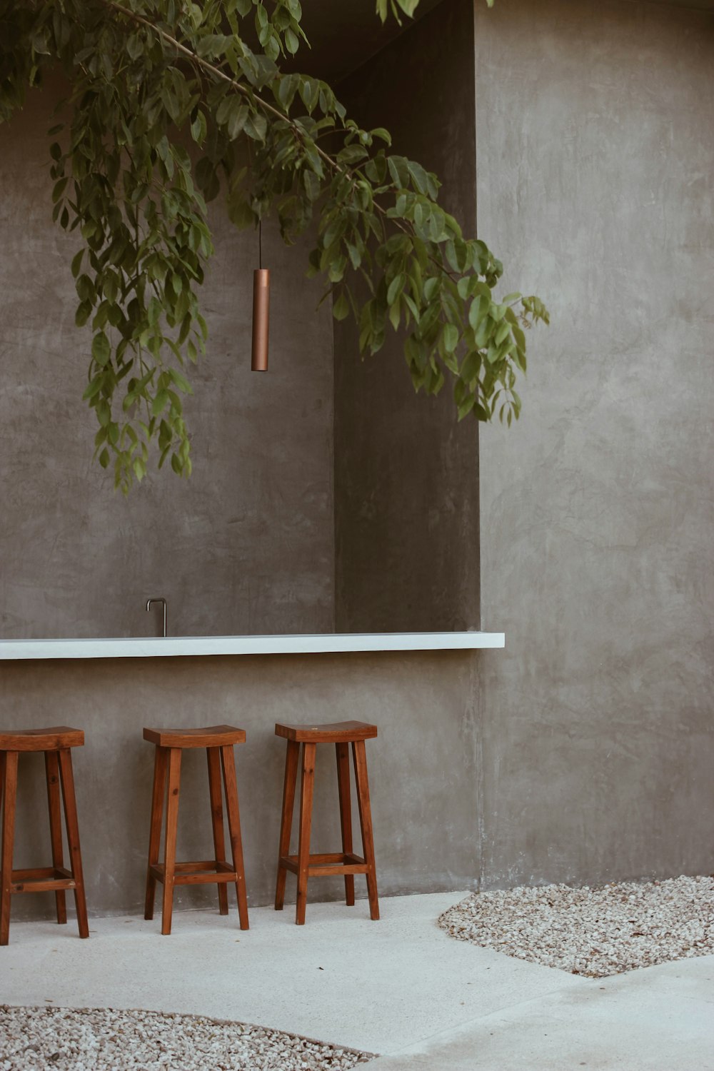 a group of stools in front of a tree