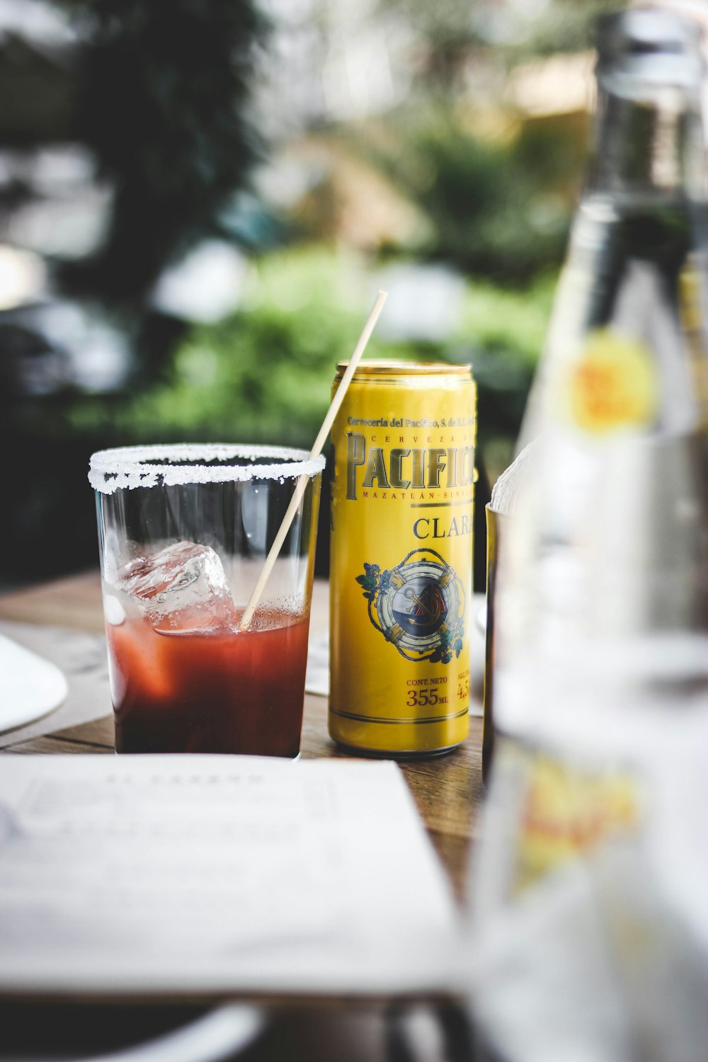 a glass of beer and a bottle of beer on a table