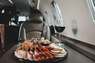 a plate of food and a glass of wine on a table