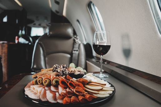 a plate of food and a glass of wine on a table