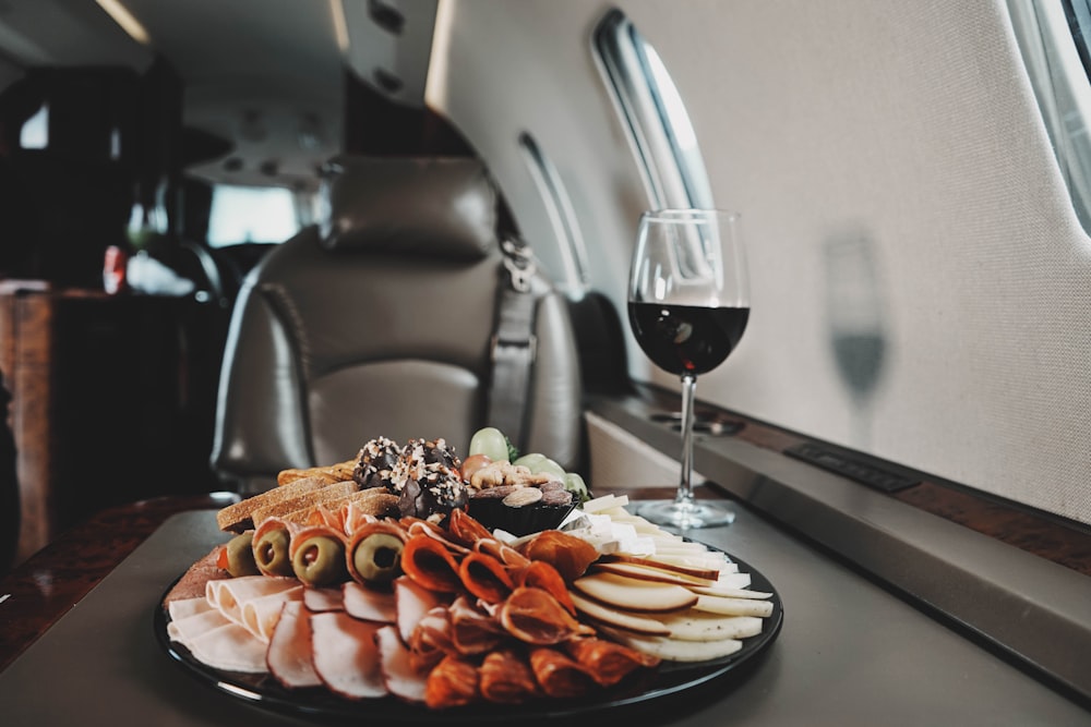 a plate of food and a glass of wine on a table