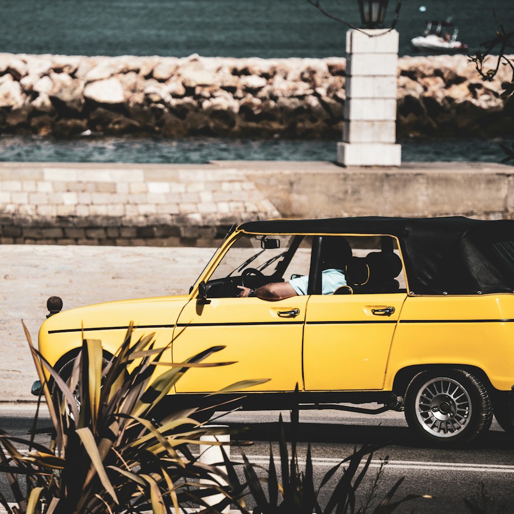 a yellow car parked on the side of a road