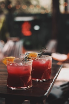 a group of drinks with fruit