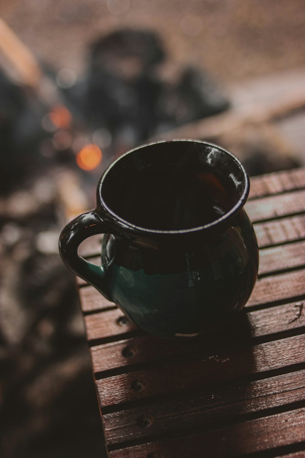 a black mug on a wood surface