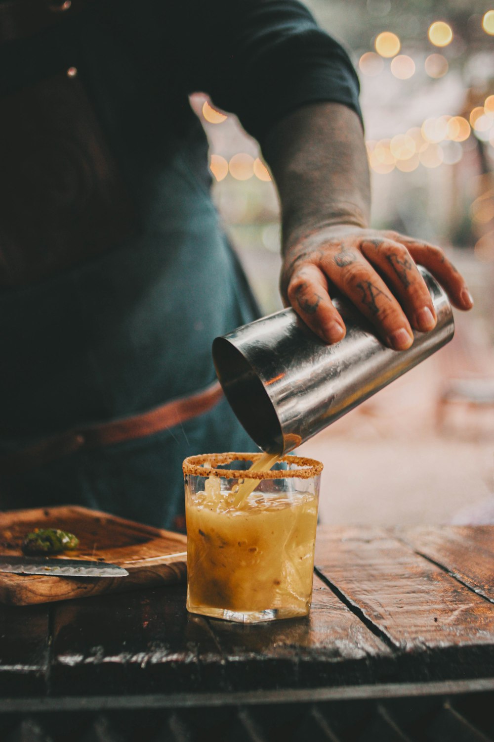 a person cutting a glass of beer