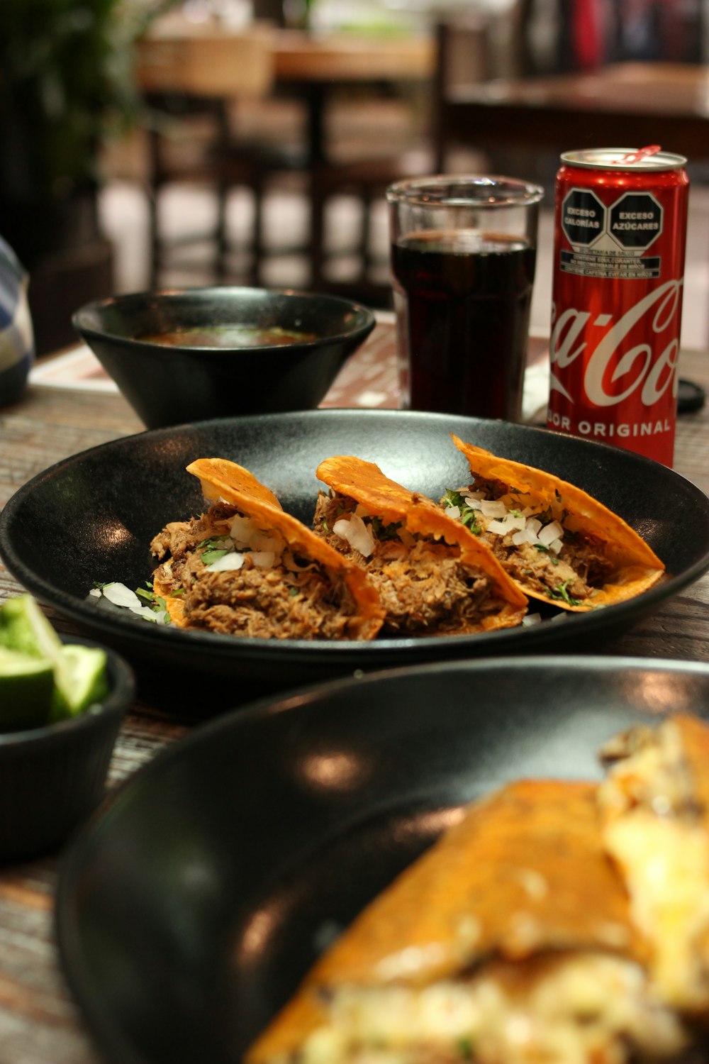 a plate of food and a can of beer on a table
