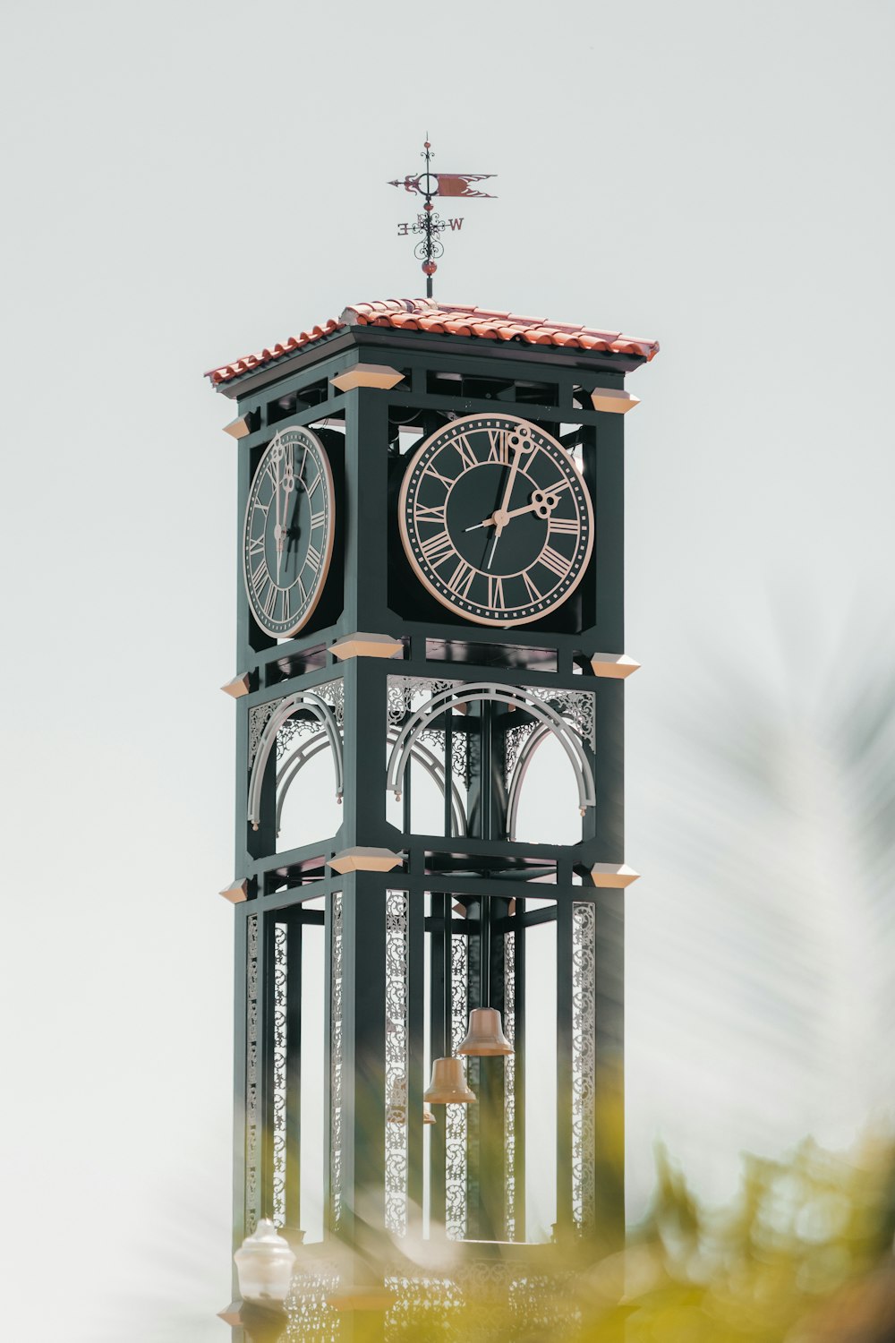 a clock tower with a weather vane on top