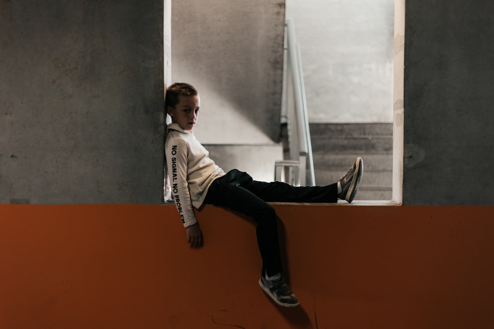 a man sitting on a window ledge