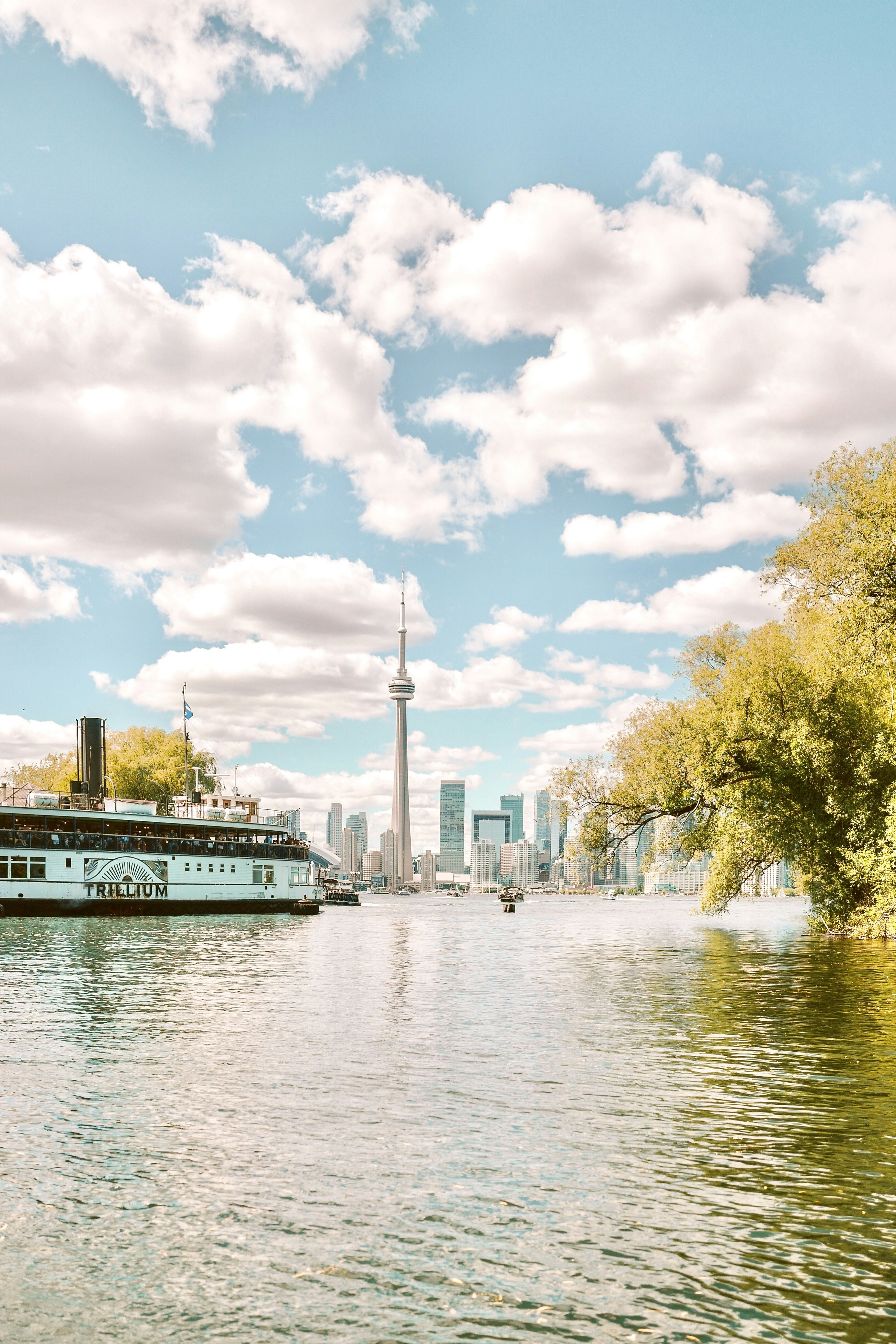 a river with a boat and a city in the background