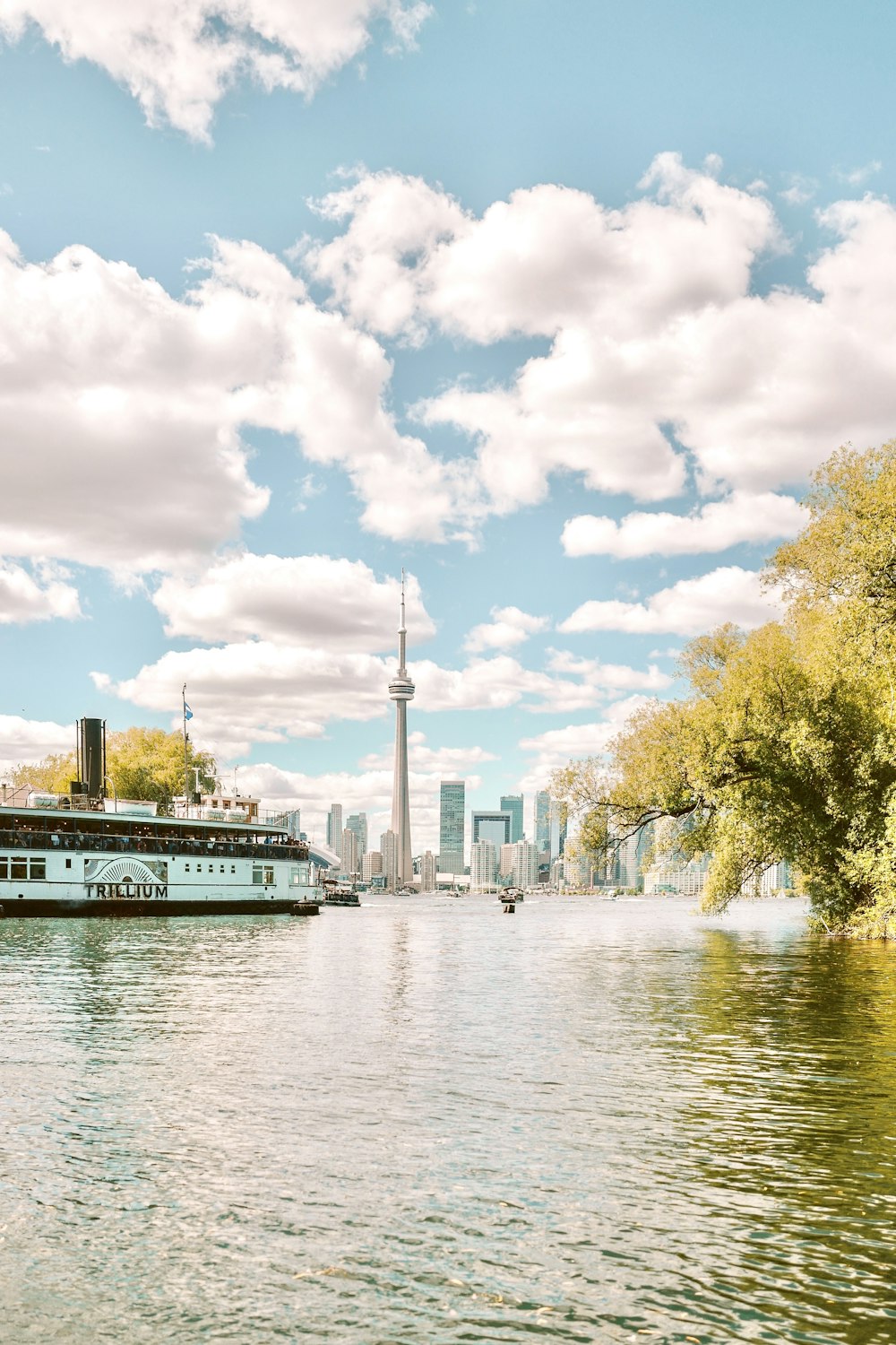 a river with a boat and a city in the background