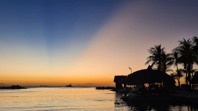 A peaceful beach scene from an international tropical destination at sunset.