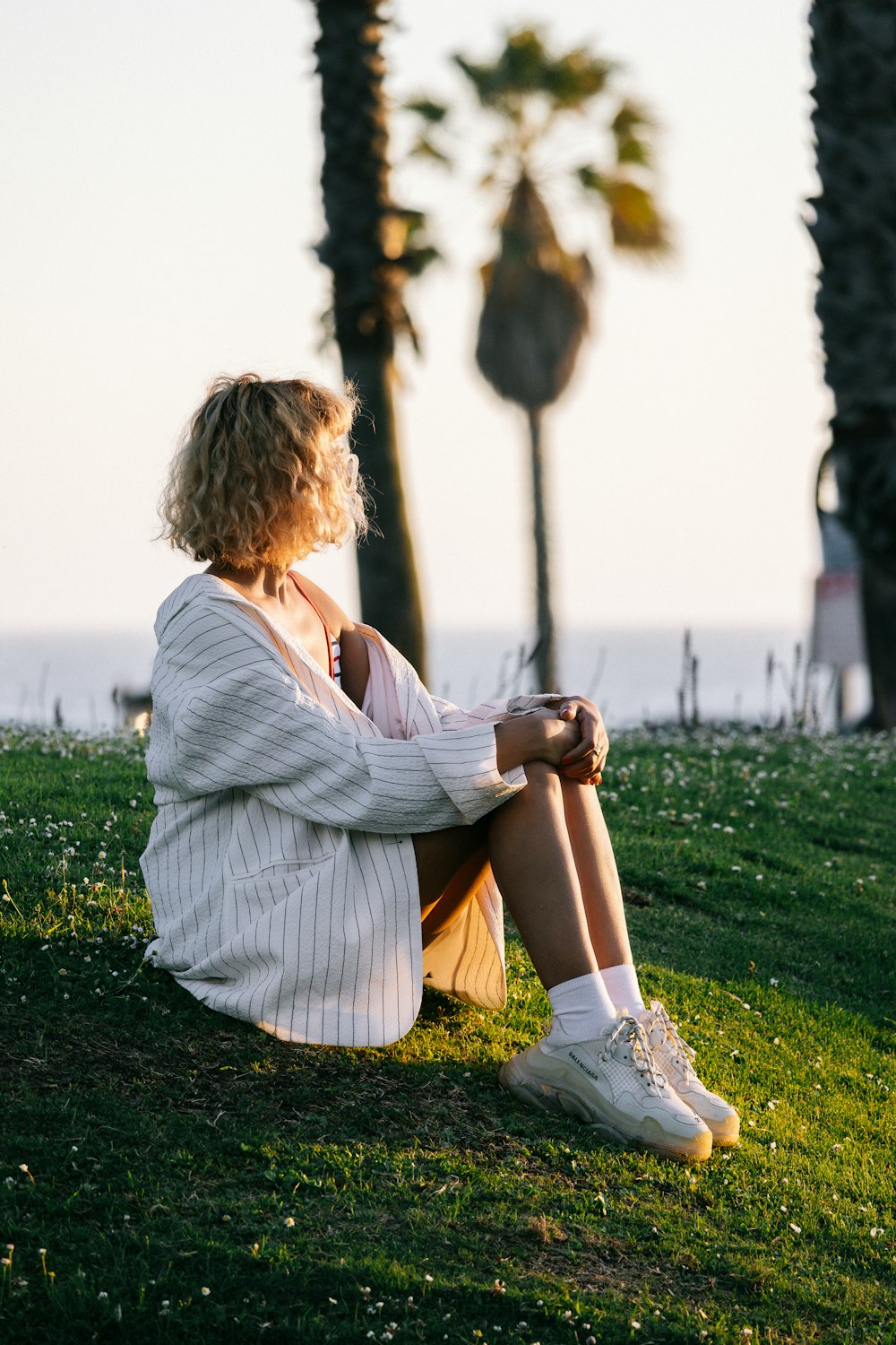 a woman sitting on grass