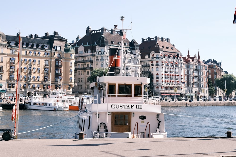 a boat docked in front of a large building