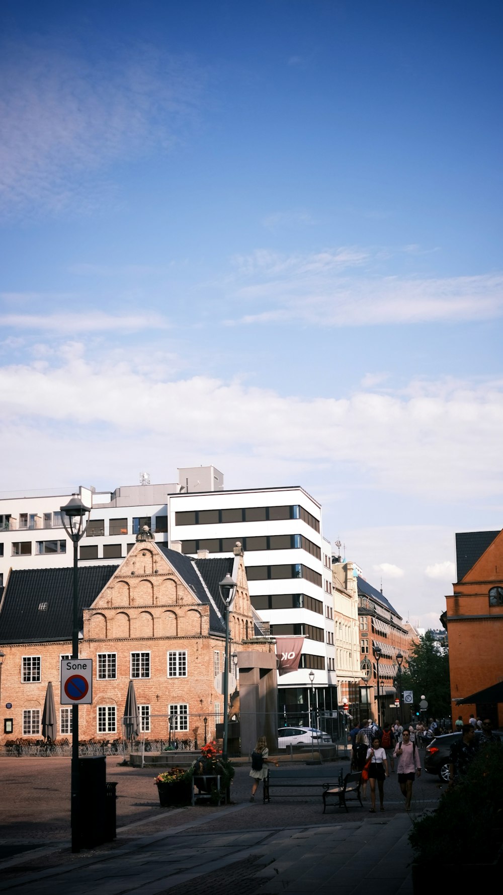 a group of people walking on a street next to a building