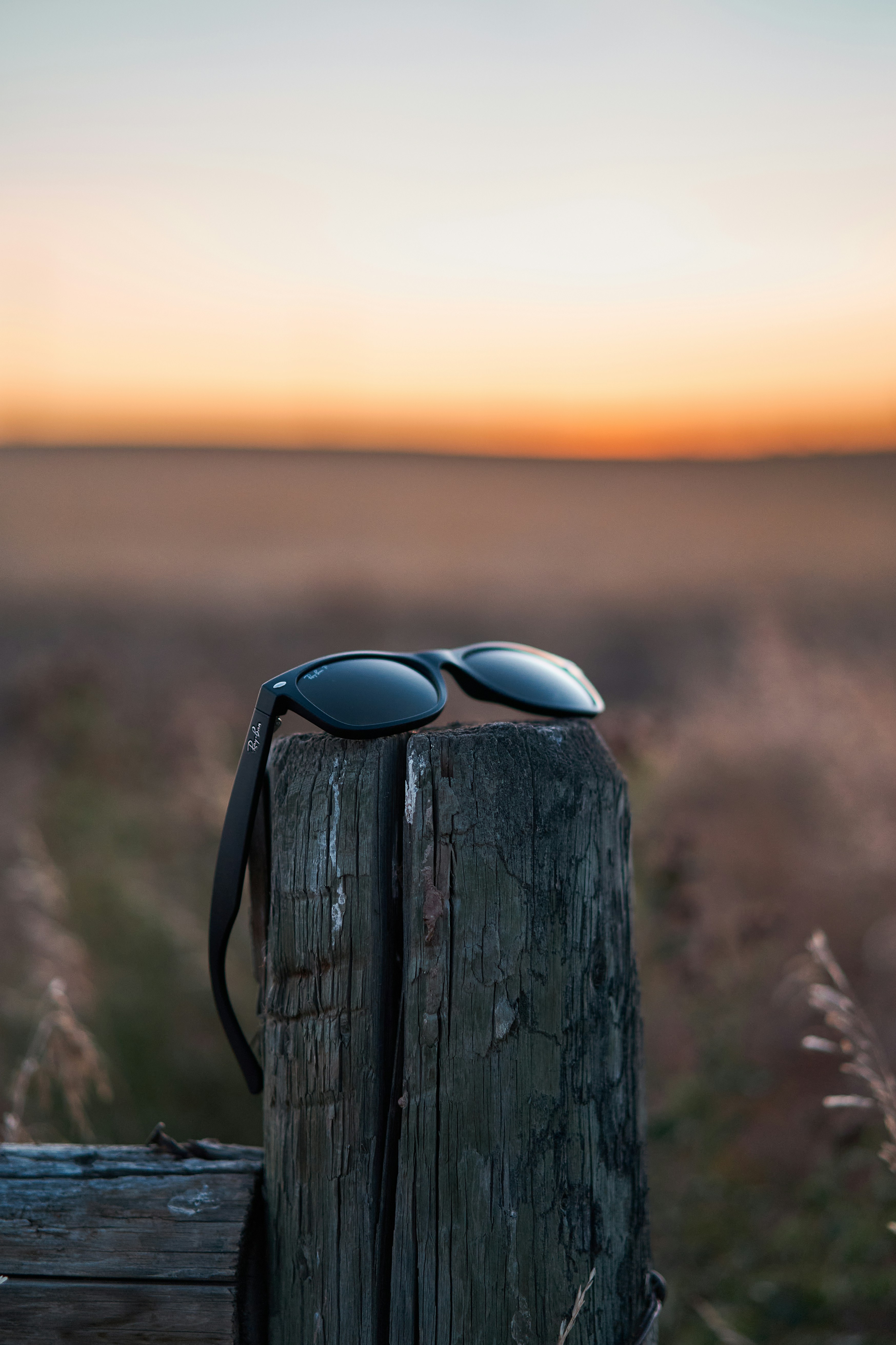 a pair of sunglasses on a wooden post