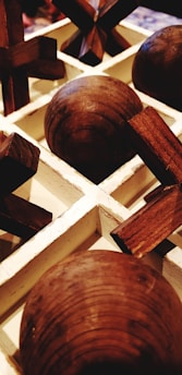 A close-up of handcrafted wooden memory game pieces laid out on a table