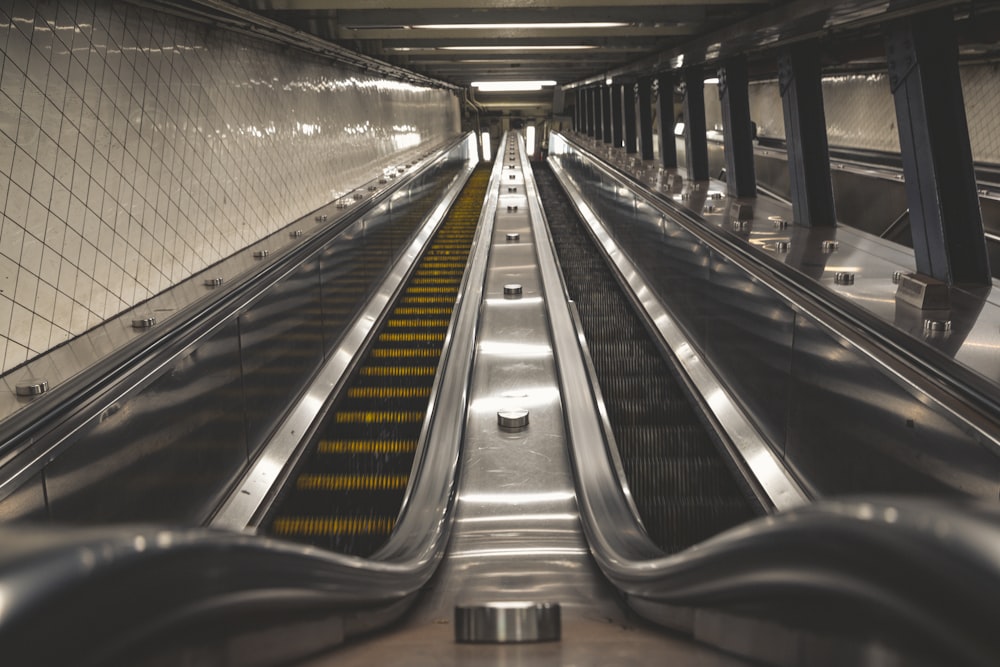 a long escalator in a subway station