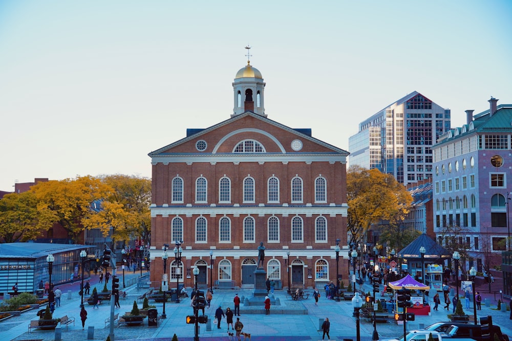a large brick building with a dome with Faneuil Hall in the background