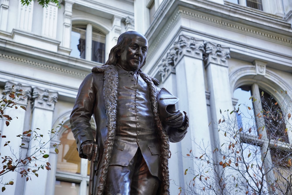 a statue of a person in front of a building