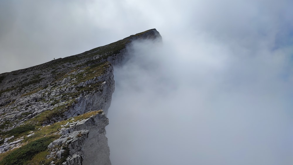 a cliff with a foggy sky