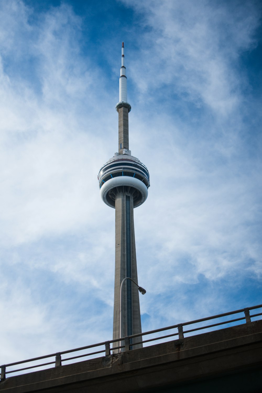 a tall tower with a blue sky with CN Tower in the background