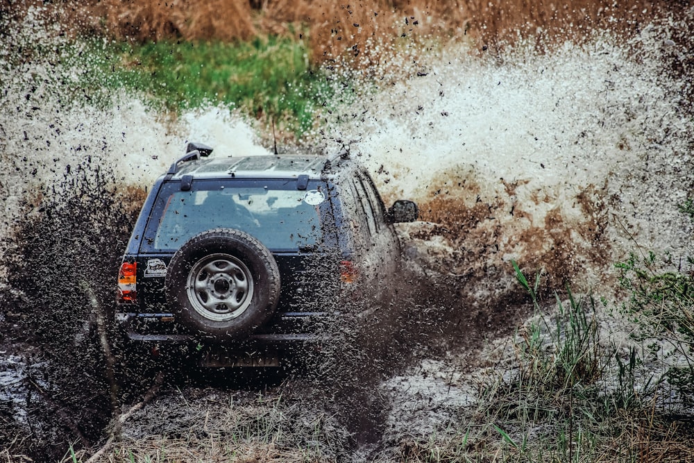 a car driving through a muddy road