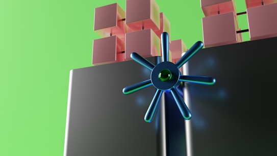 A futuristic digital illustration featuring stacked cubes in shades of pink and a large, metallic blue circular structure with radial spokes. The background is a bright green, adding a vibrant contrast.