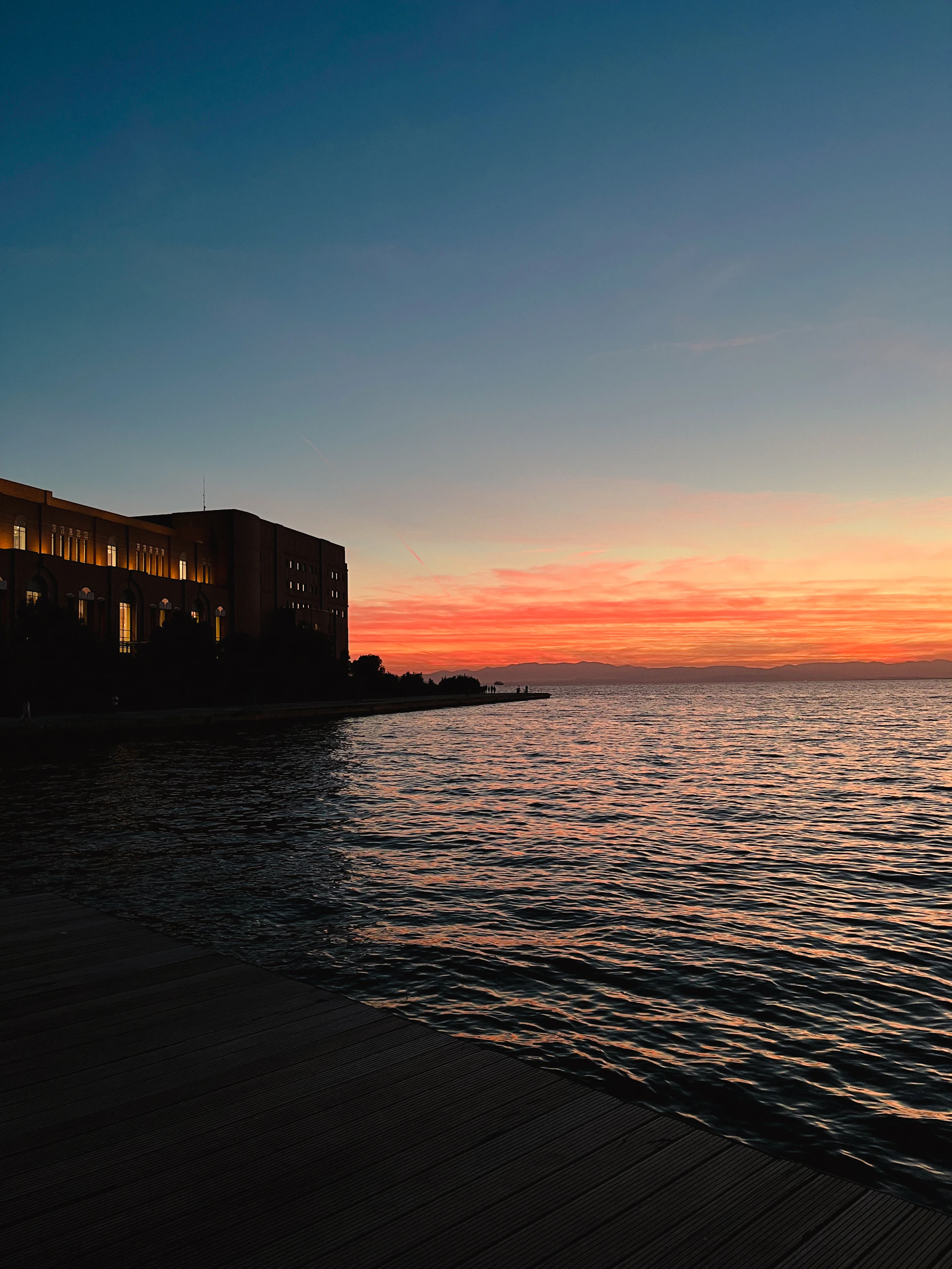 a building next to a body of water