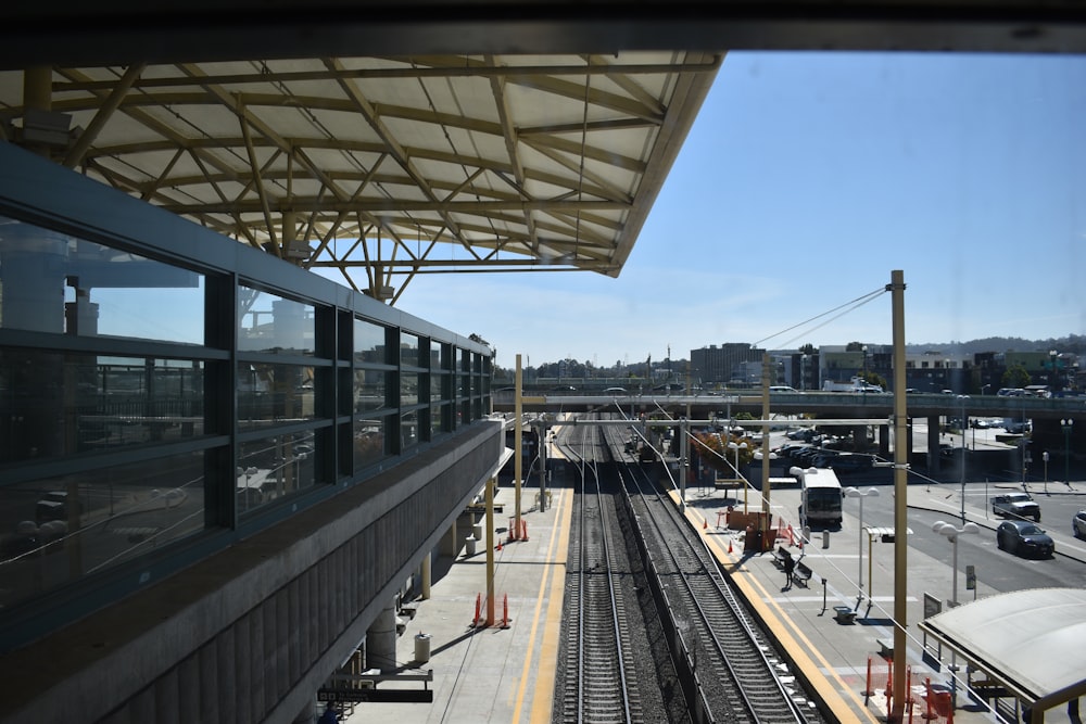 a train station with cars and a train at the platform