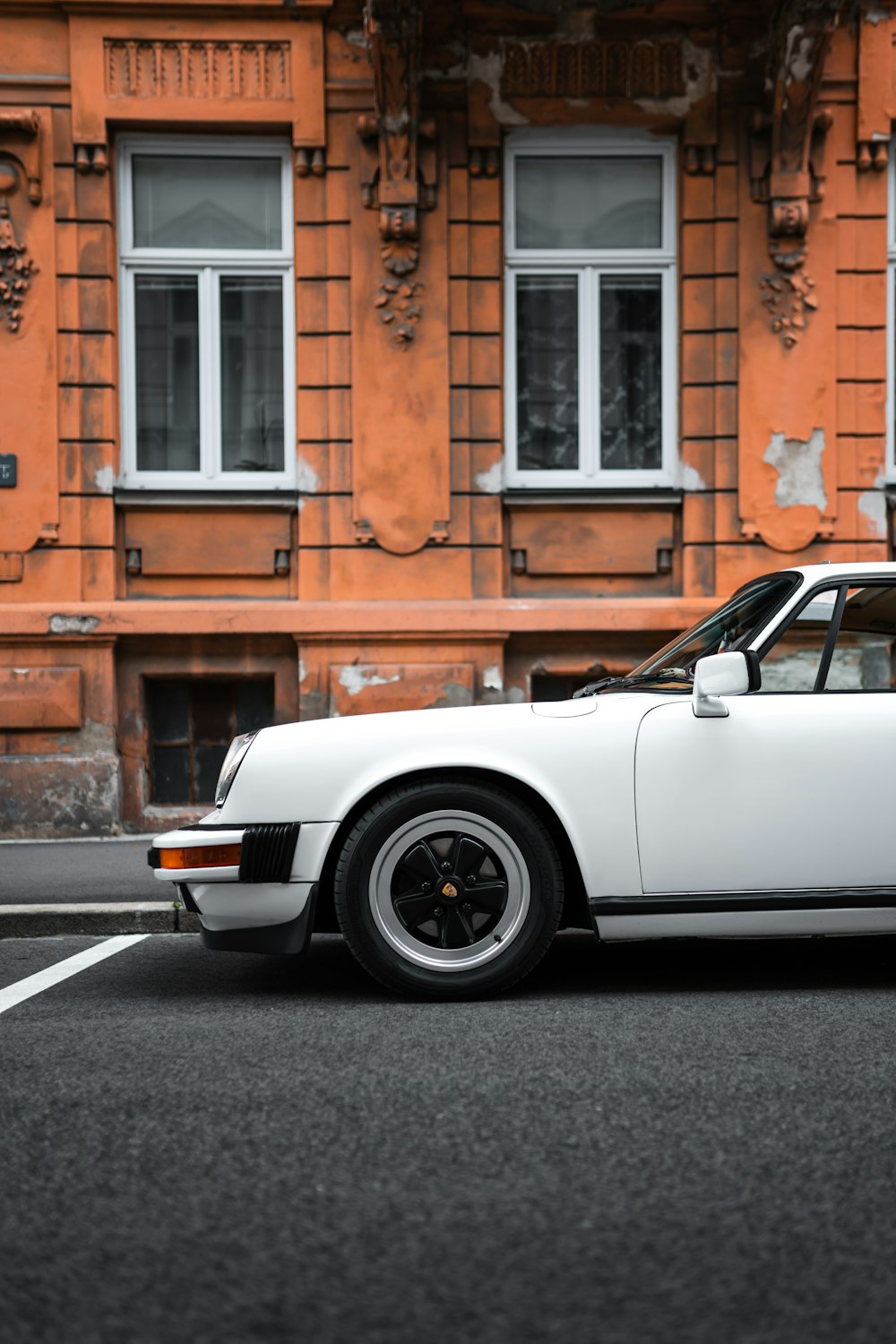 a white car parked in front of a building