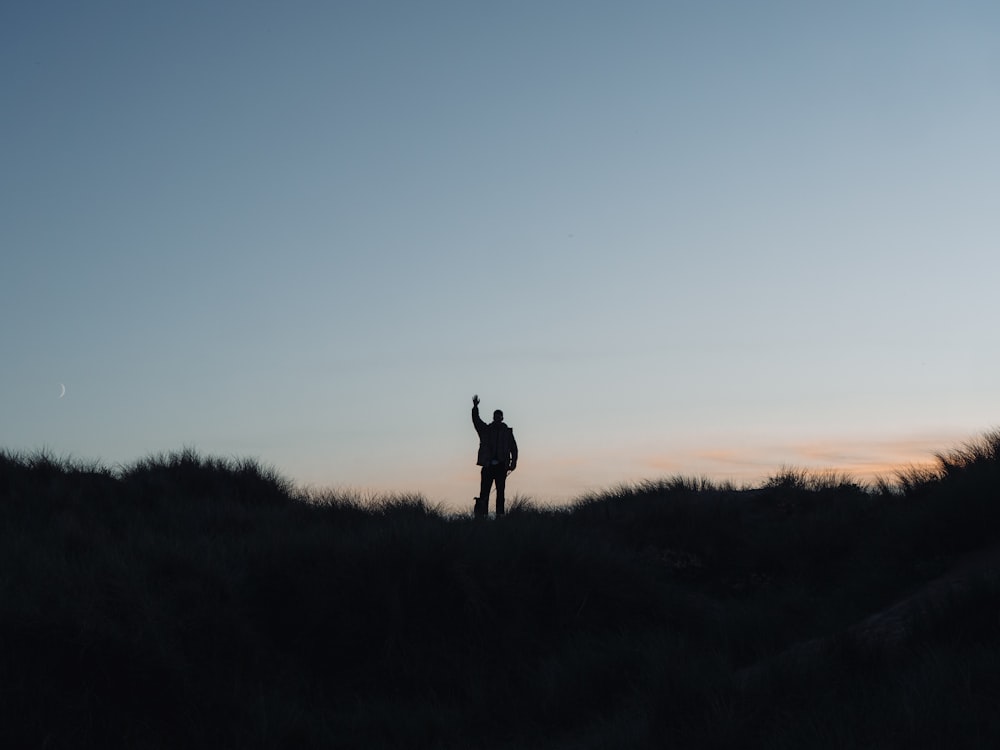 a person standing on a hill