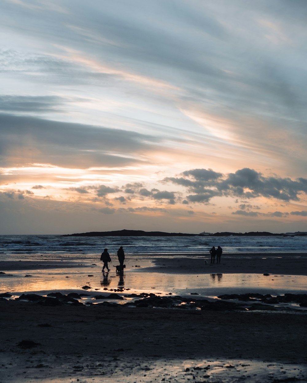 people walking on the beach