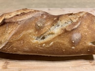 Close-up of a golden loaf of bread with a crispy crust.