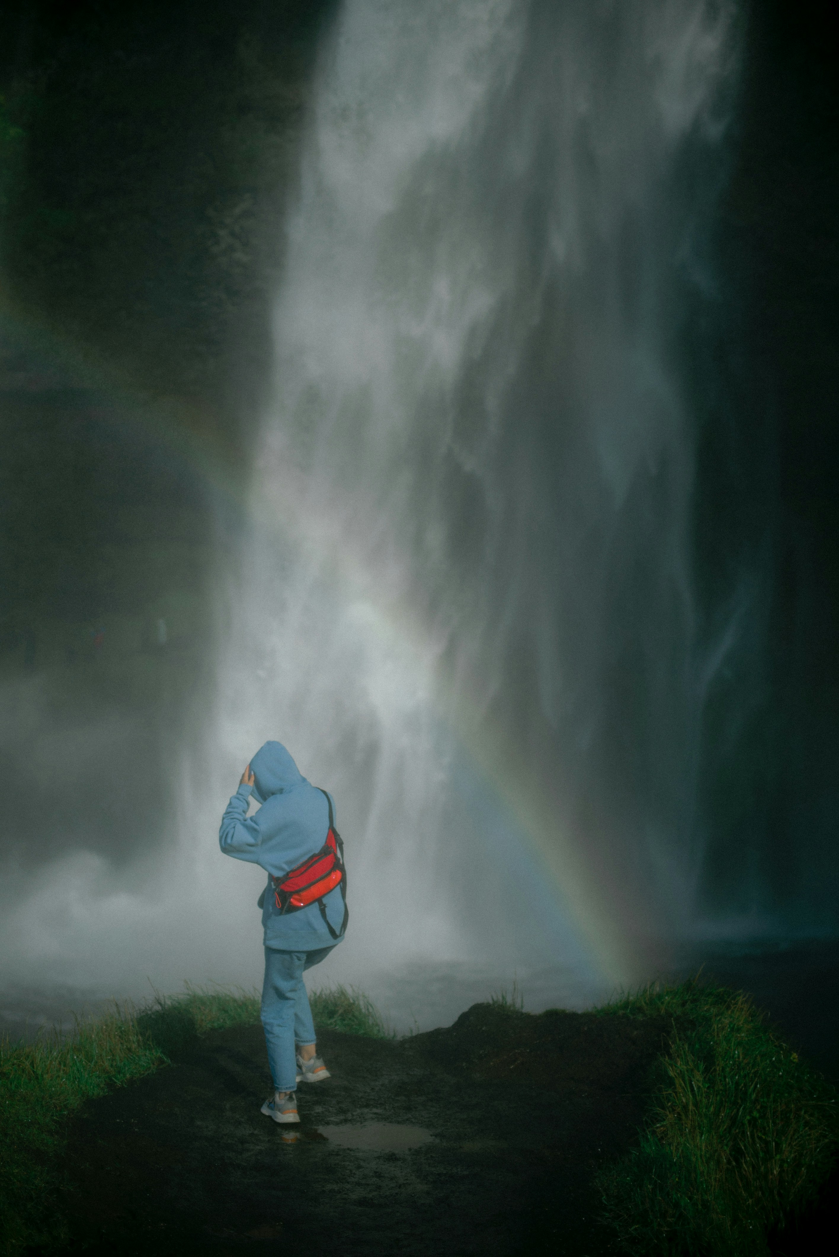 A person standing in front of a waterfall photo – Free Photo Image on ...