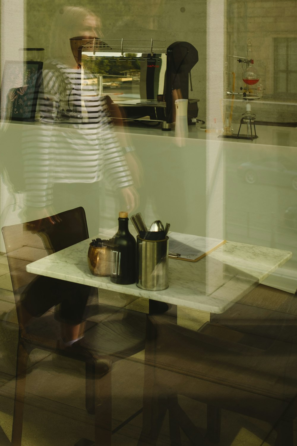 a table with a glass and bottles on it