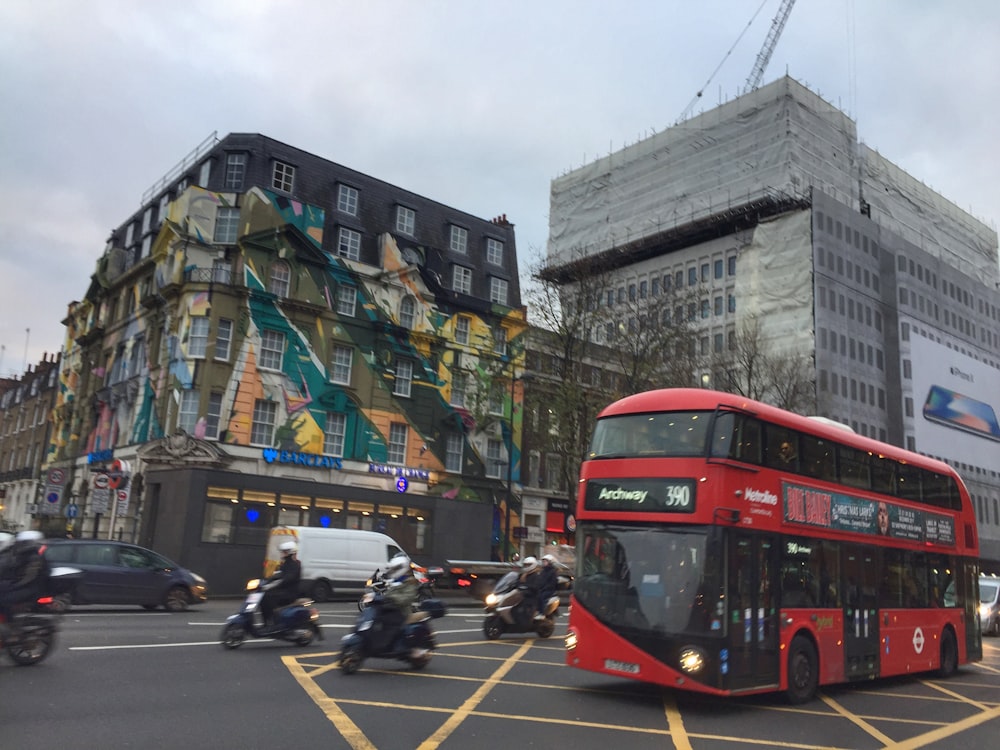 a red double decker bus on the street