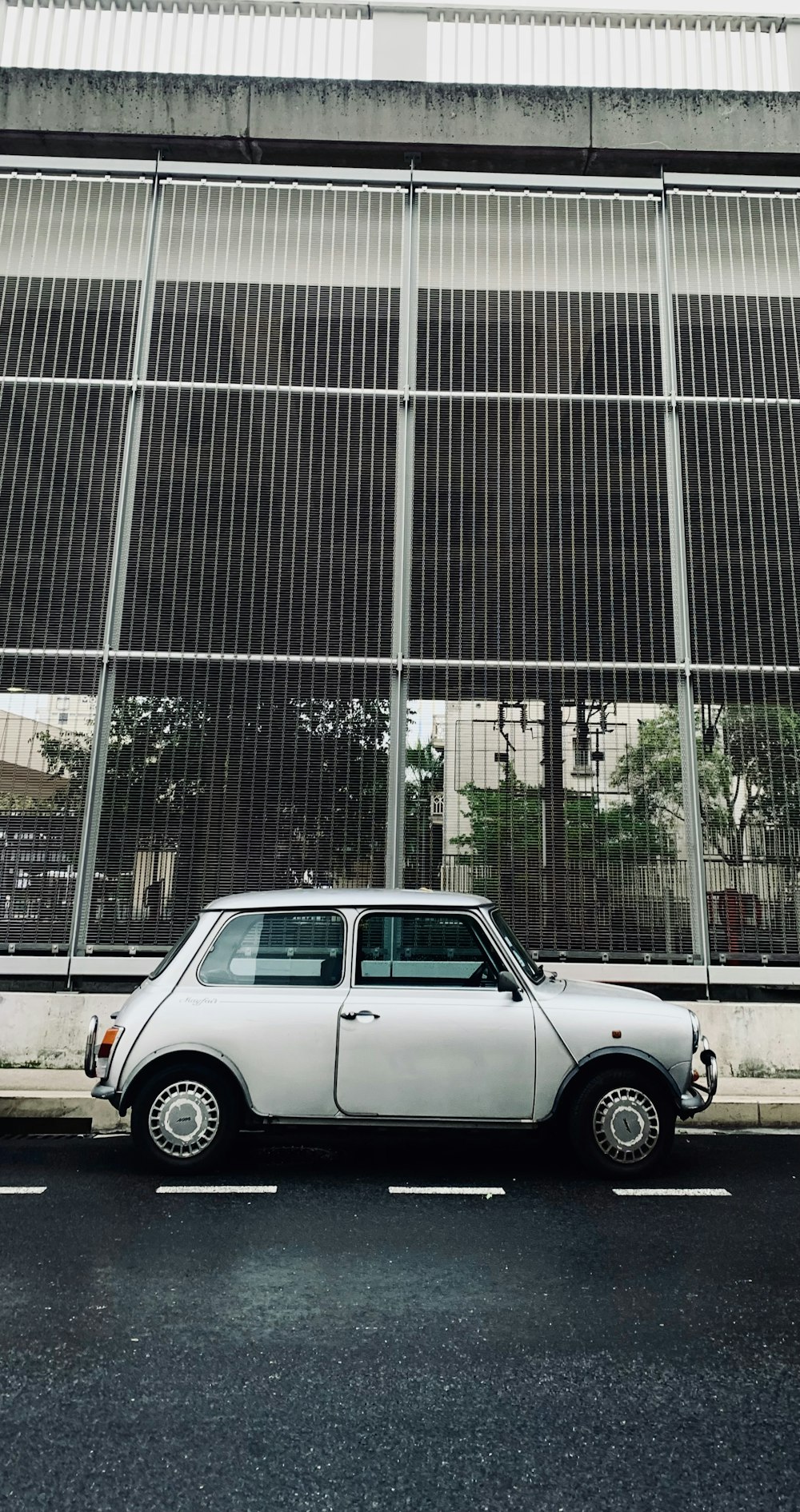 a white car parked in front of a building