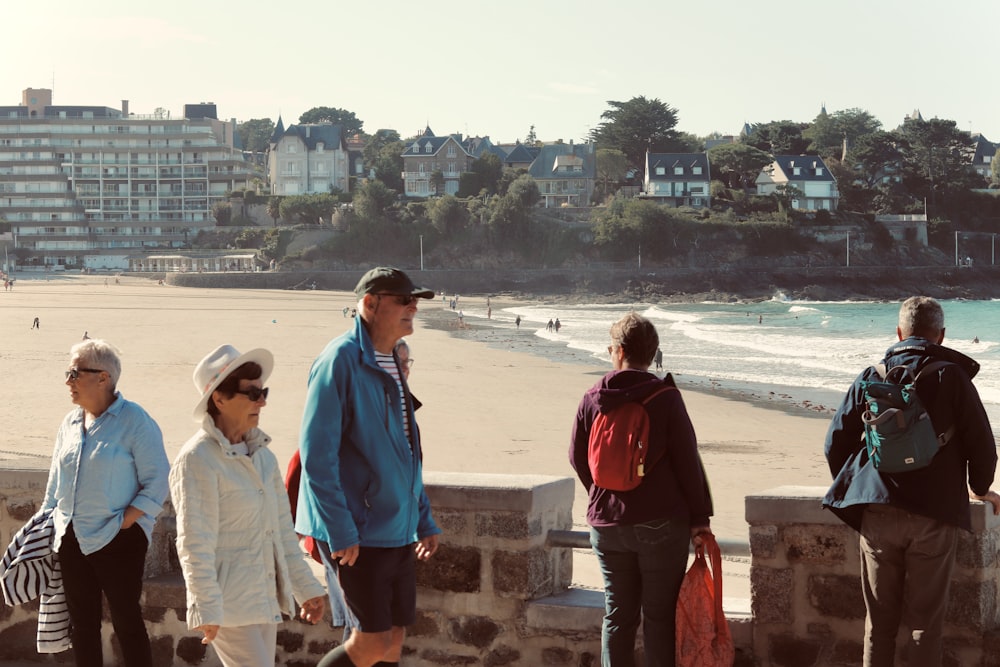 a group of people standing on a beach