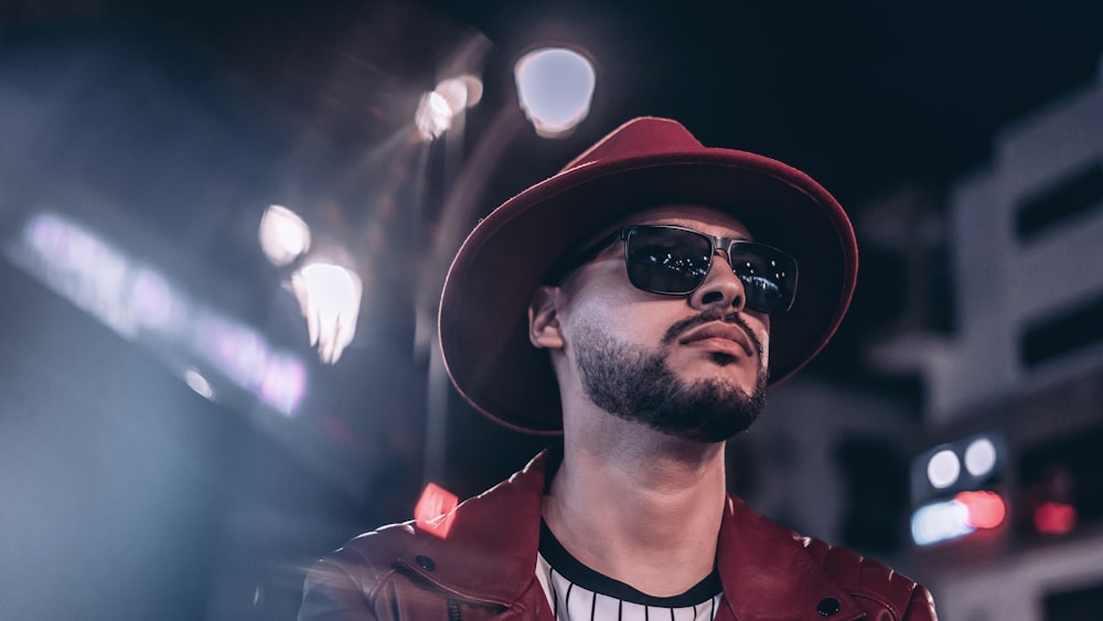 a man wearing a hat and sunglasses