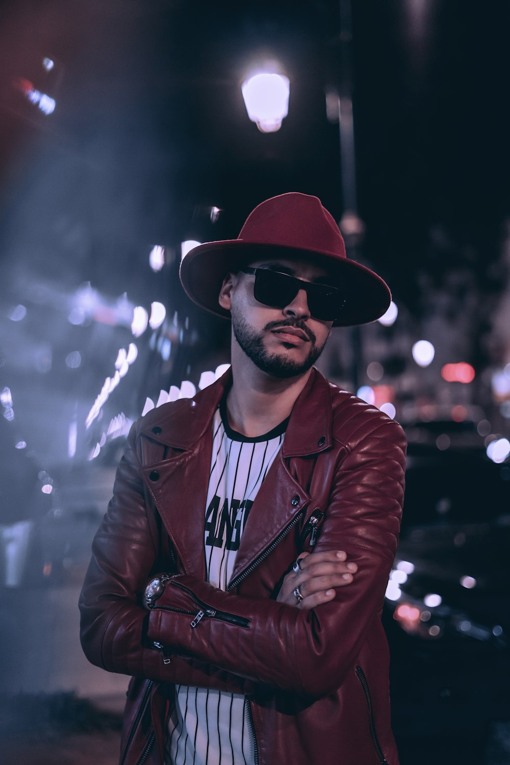 a man wearing a hat and sunglasses