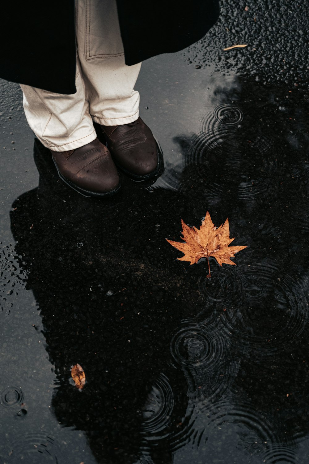 a person standing on a wet road