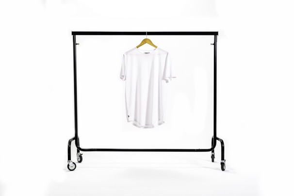 Casual t-shirt paired with relaxed-fit pants on a wooden hanger