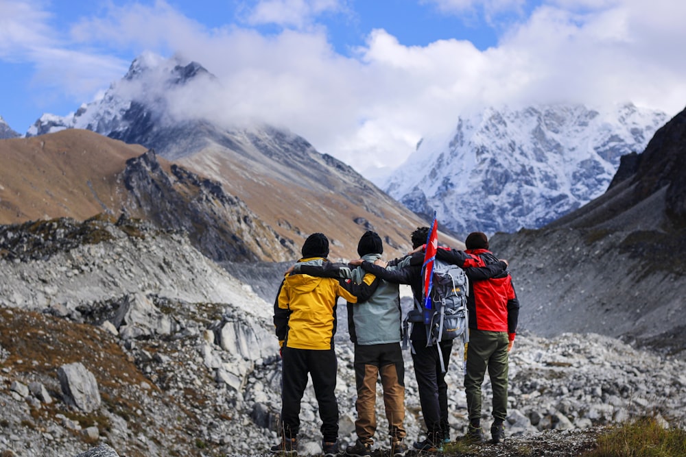 a group of people with skis on a mountain