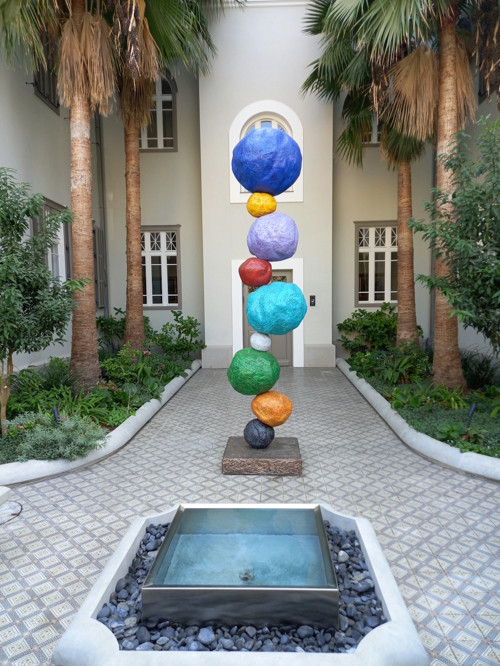 a building with a fountain and balloons