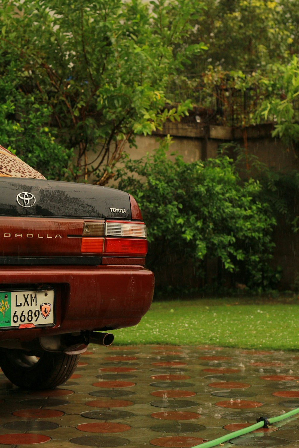 a red truck parked on a wet road