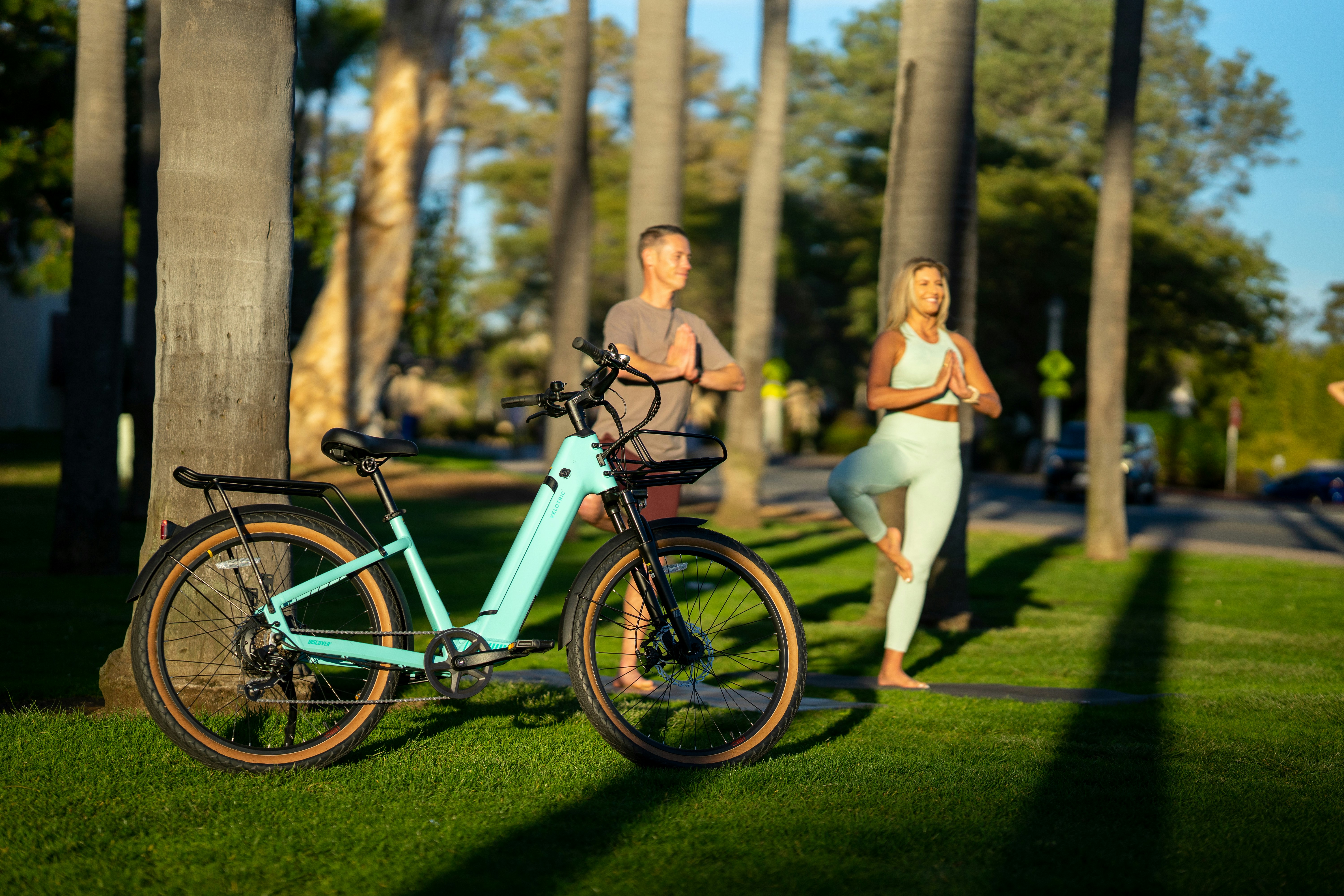 a man and woman posing next to a bicycle